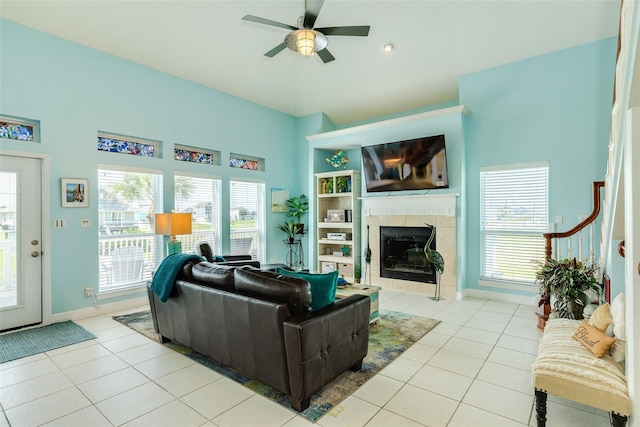 18614 Warrior Rd, Galveston, TX 77554 - living room featuring a fireplace, ceiling fan, and light tile patterned flooring