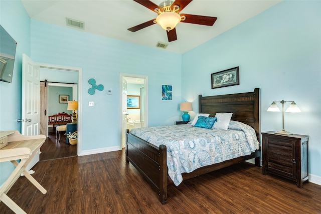 18614 Warrior Rd, Galveston, TX 77554 - bedroom with wood finished floors, a barn door, ceiling fan, and connected bathroom