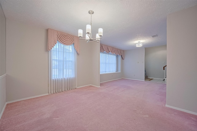 2415 Pebbledowne Cir, Sugar Land, TX 77478 - unfurnished room with a chandelier, a textured ceiling, and light colored carpet