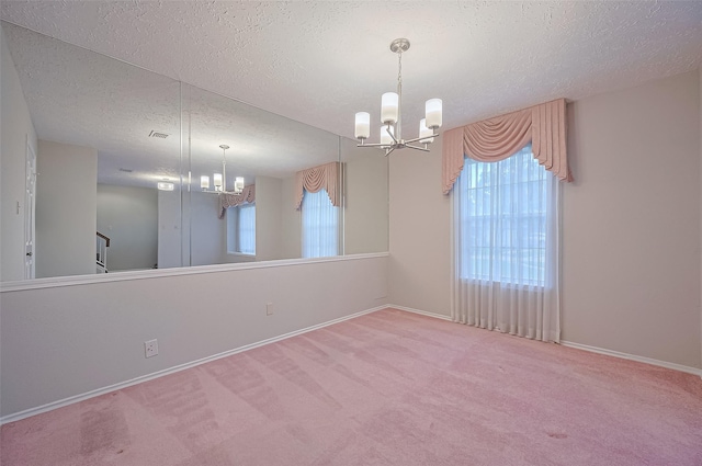 2415 Pebbledowne Cir, Sugar Land, TX 77478 - carpeted spare room featuring a chandelier, a textured ceiling, and plenty of natural light