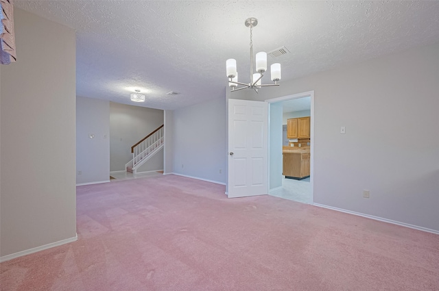 2415 Pebbledowne Cir, Sugar Land, TX 77478 - unfurnished room with a textured ceiling, a chandelier, stairway, and light carpet