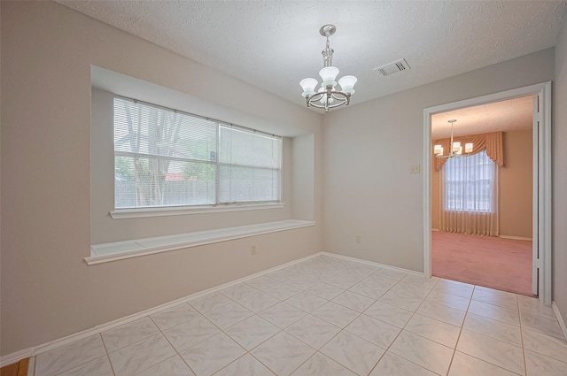 2415 Pebbledowne Cir, Sugar Land, TX 77478 - spare room featuring a chandelier, light tile patterned floors, and a textured ceiling