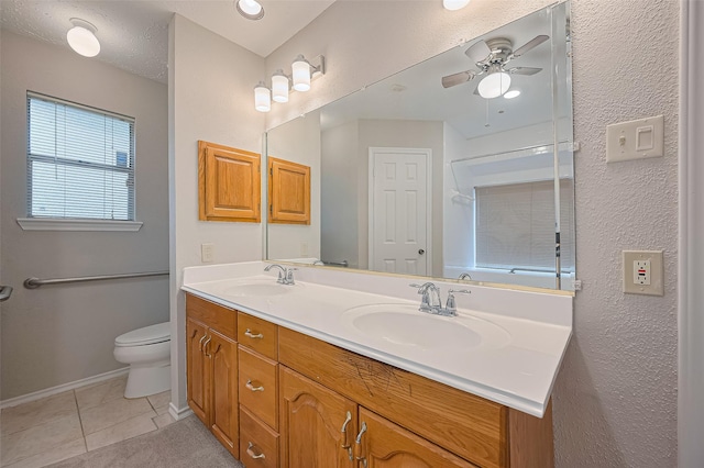 2415 Pebbledowne Cir, Sugar Land, TX 77478 - bathroom featuring double vanity, ceiling fan, tile patterned flooring, a shower, and a textured wall