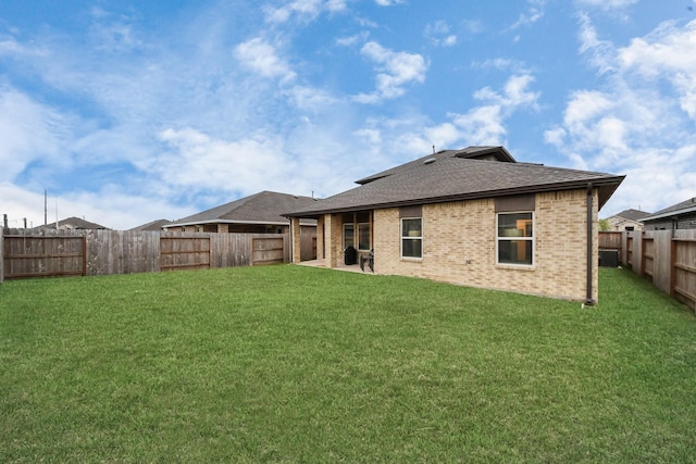 4985 Blue Beetle Ridge Dr, Katy, TX 77493 - back of house with a fenced backyard, brick siding, roof with shingles, and a patio