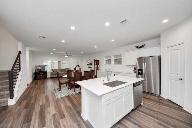 4985 Blue Beetle Ridge Dr, Katy, TX 77493 - kitchen featuring appliances with stainless steel finishes, recessed lighting, light countertops, white cabinets, and a kitchen island with sink