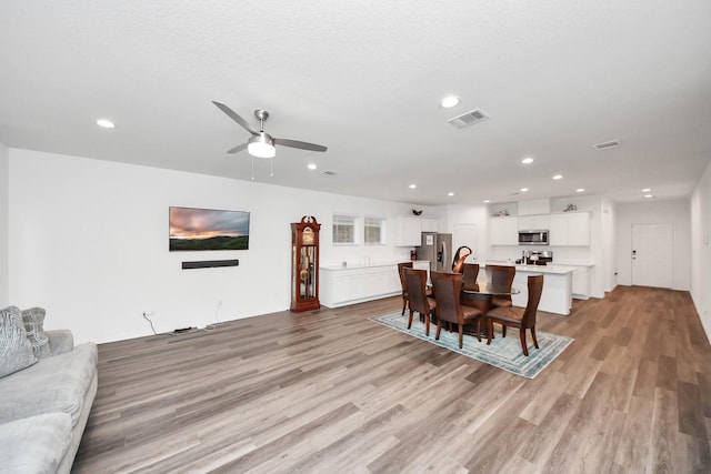 4985 Blue Beetle Ridge Dr, Katy, TX 77493 - dining room featuring light wood-style flooring, a ceiling fan, and recessed lighting