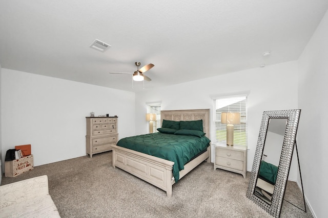 4985 Blue Beetle Ridge Dr, Katy, TX 77493 - bedroom with multiple windows, carpet, and ceiling fan