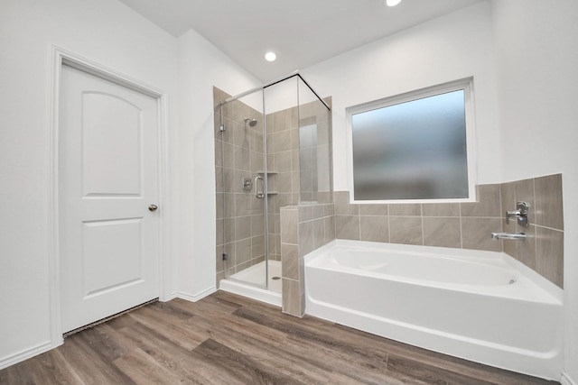 4985 Blue Beetle Ridge Dr, Katy, TX 77493 - bathroom featuring a bath, a shower stall, wood finished floors, and recessed lighting