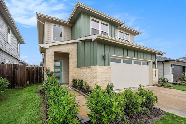 12810 Barnesbury Ln, Houston, TX 77047 - view of front of property with board and batten siding, driveway, and a garage