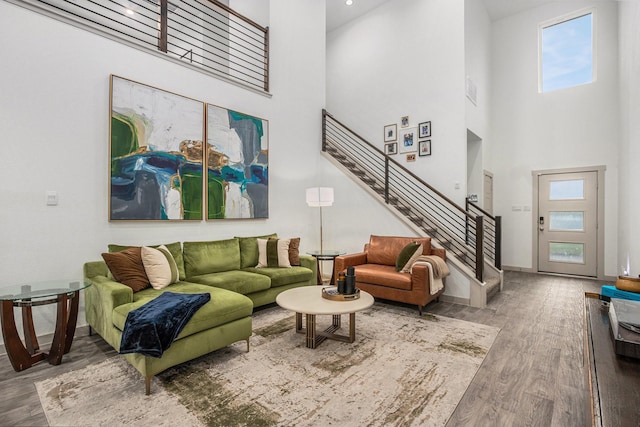12810 Barnesbury Ln, Houston, TX 77047 - living area featuring stairway, a towering ceiling, and wood finished floors
