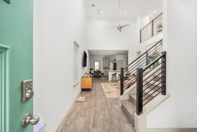 12810 Barnesbury Ln, Houston, TX 77047 - entrance foyer featuring stairway, wood finished floors, a high ceiling, a ceiling fan, and recessed lighting