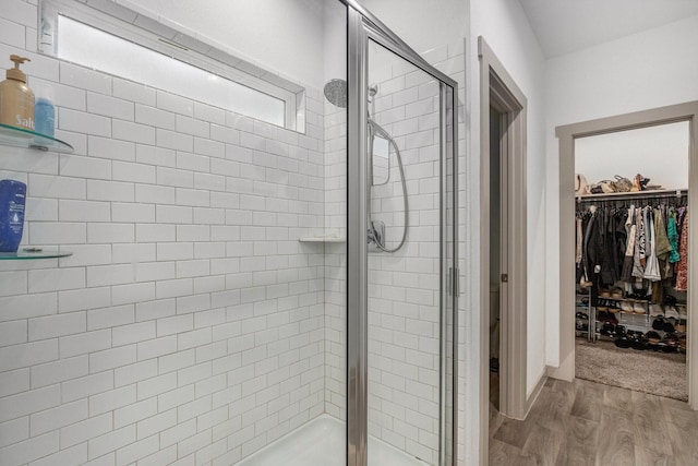 12810 Barnesbury Ln, Houston, TX 77047 - full bath with a stall shower, a spacious closet, and wood finished floors
