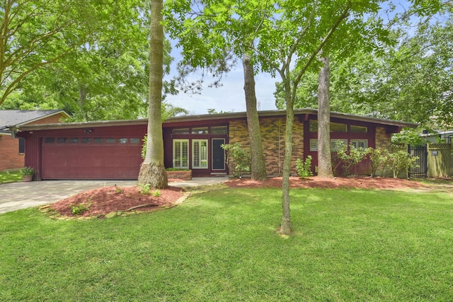 1202 Fay Rd, Kemah, TX 77565 - view of front of house featuring an attached garage, concrete driveway, and french doors