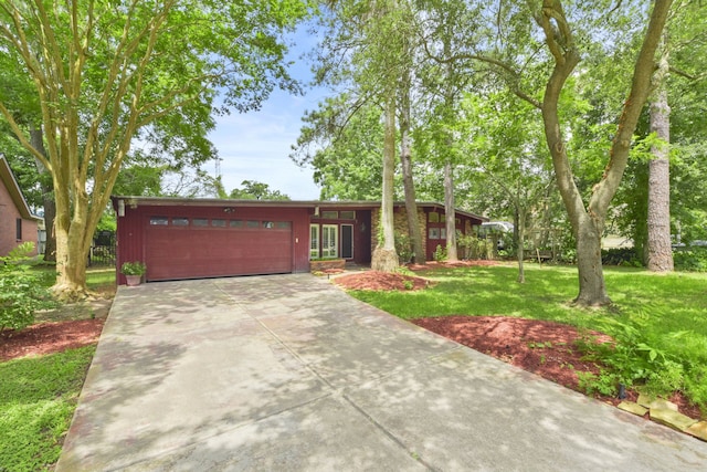1202 Fay Rd, Kemah, TX 77565 - mid-century home featuring a garage, a front lawn, and driveway