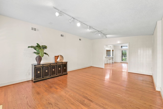 1202 Fay Rd, Kemah, TX 77565 - unfurnished room with wood finished floors, a textured ceiling, and rail lighting