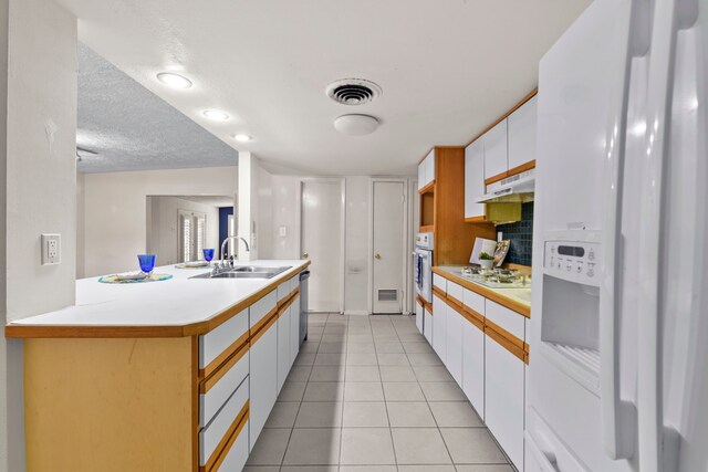 1202 Fay Rd, Kemah, TX 77565 - kitchen featuring white appliances, light countertops, white cabinetry, and under cabinet range hood