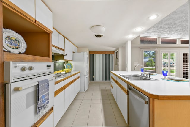 1202 Fay Rd, Kemah, TX 77565 - kitchen featuring white appliances, light countertops, white cabinets, under cabinet range hood, and light tile patterned flooring