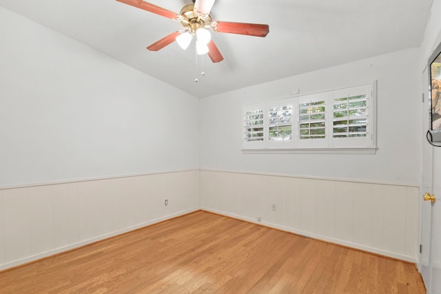 1202 Fay Rd, Kemah, TX 77565 - spare room with wood finished floors, a wainscoted wall, and a ceiling fan