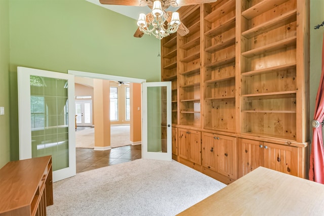 26150 Crown Ranch Blvd, Montgomery, TX 77316 - carpeted bedroom with french doors, tile patterned flooring, a chandelier, and a towering ceiling