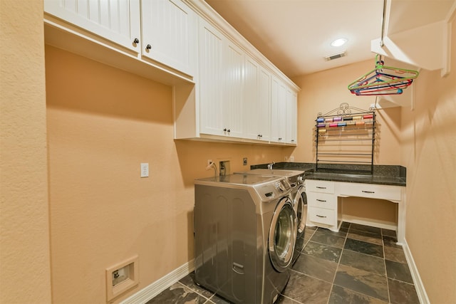 26150 Crown Ranch Blvd, Montgomery, TX 77316 - laundry area featuring cabinet space, independent washer and dryer, and dark stone finish floors