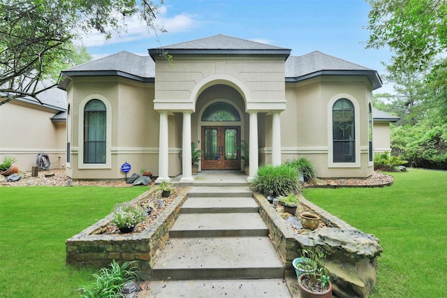 26150 Crown Ranch Blvd, Montgomery, TX 77316 - view of front of home with french doors, stucco siding, a front lawn, and a shingled roof