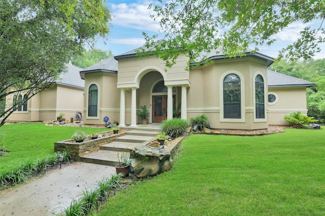26150 Crown Ranch Blvd, Montgomery, TX 77316 - mediterranean / spanish-style house featuring stucco siding, a front lawn, and roof with shingles