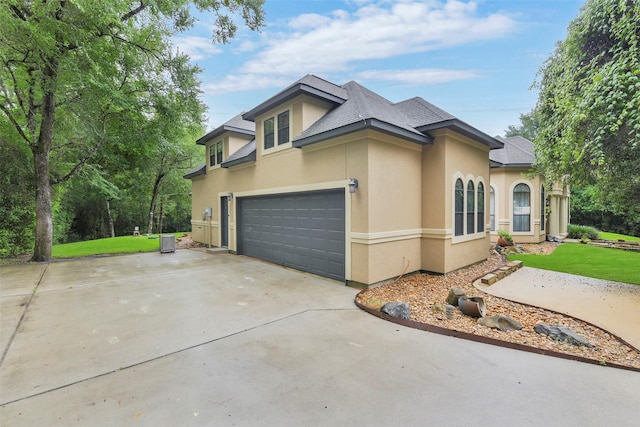 26150 Crown Ranch Blvd, Montgomery, TX 77316 - view of front of house featuring stucco siding, driveway, an attached garage, and roof with shingles