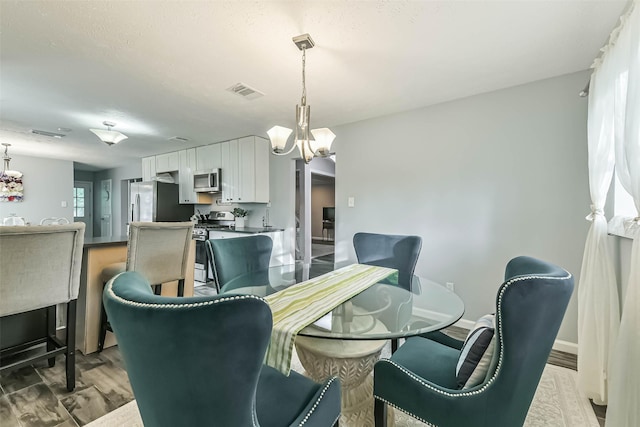 637 Mosswood Dr, Conroe, TX 77302 - dining space featuring a chandelier and wood finished floors