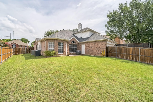 412 Belmont Ct, Lewisville, TX 75067 - rear view of property featuring brick siding, a chimney, a fenced backyard, and roof with shingles