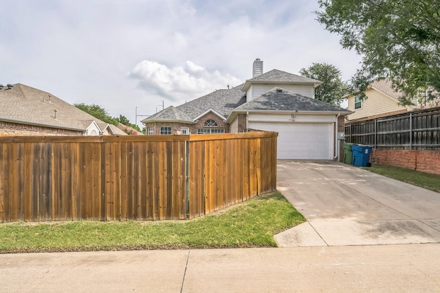 412 Belmont Ct, Lewisville, TX 75067 - view of property exterior featuring a garage, driveway, a chimney, and brick siding