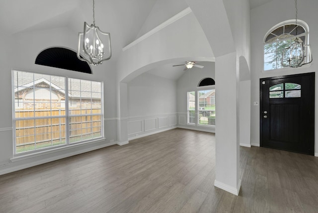 412 Belmont Ct, Lewisville, TX 75067 - entryway with a chandelier, arched walkways, high vaulted ceiling, a ceiling fan, and wood finished floors