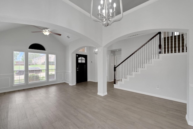412 Belmont Ct, Lewisville, TX 75067 - entrance foyer with arched walkways, wood finished floors, ceiling fan, stairway, and high vaulted ceiling