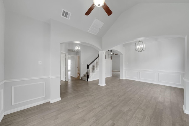 412 Belmont Ct, Lewisville, TX 75067 - spare room with a chandelier, arched walkways, ceiling fan, stairway, and high vaulted ceiling
