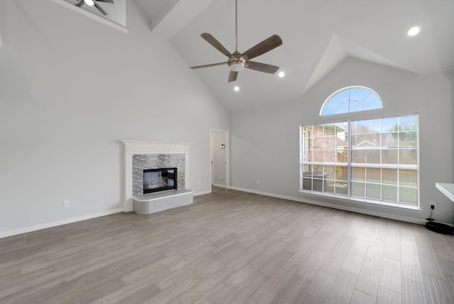 412 Belmont Ct, Lewisville, TX 75067 - unfurnished living room with ceiling fan, high vaulted ceiling, a glass covered fireplace, wood finished floors, and recessed lighting