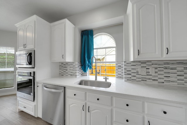 412 Belmont Ct, Lewisville, TX 75067 - kitchen featuring stainless steel appliances, white cabinets, and tasteful backsplash