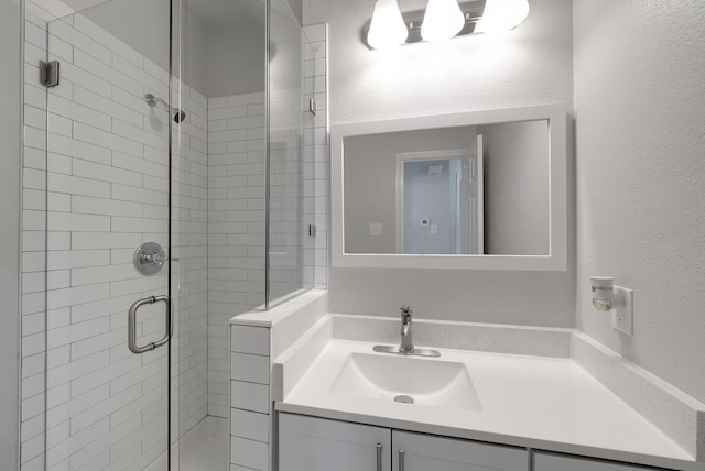 412 Belmont Ct, Lewisville, TX 75067 - full bath with a shower stall, vanity, and a textured wall