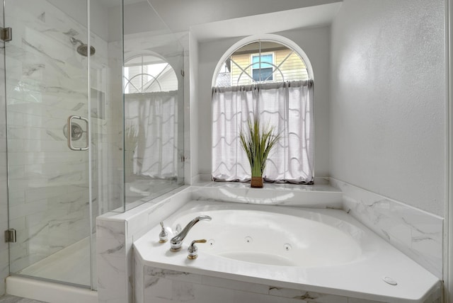 412 Belmont Ct, Lewisville, TX 75067 - full bathroom featuring a jetted tub, a marble finish shower, and a textured wall