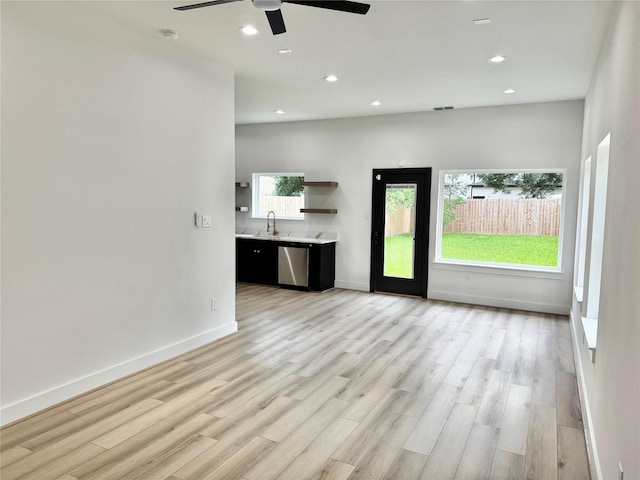 2328 Wavell St, Houston, TX 77088 - unfurnished living room featuring a ceiling fan, healthy amount of natural light, light wood finished floors, and recessed lighting