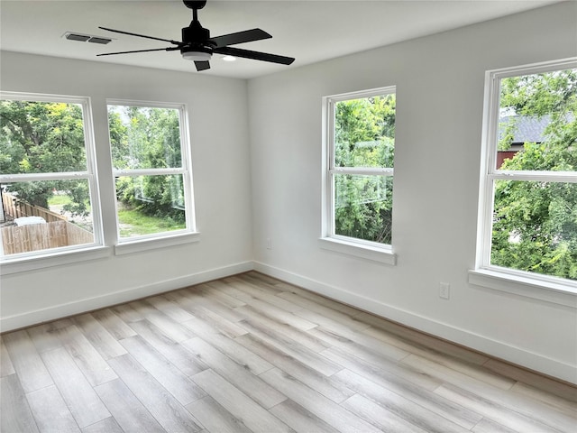 2328 Wavell St, Houston, TX 77088 - empty room with healthy amount of natural light, ceiling fan, and light wood-style flooring