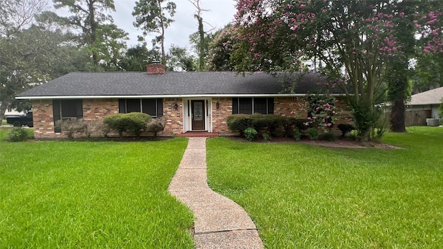 2514 Creekleaf Rd, Houston, TX 77068 - ranch-style house featuring a front lawn, a chimney, a shingled roof, and brick siding