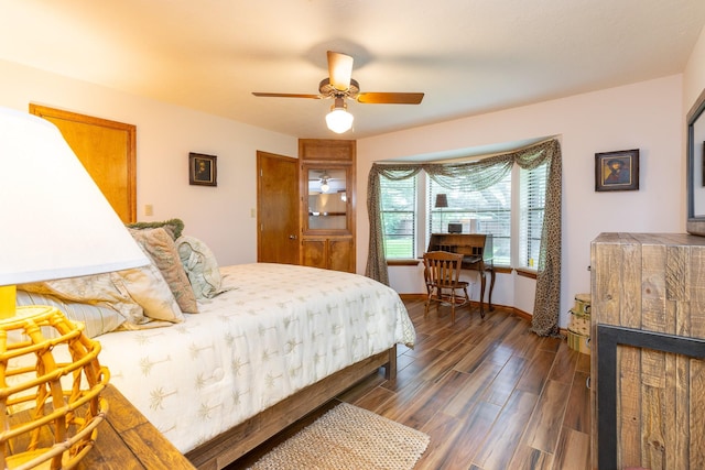1211 Tall Pines Dr, Friendswood, TX 77546 - bedroom with dark wood-style floors, ceiling fan, and a fireplace
