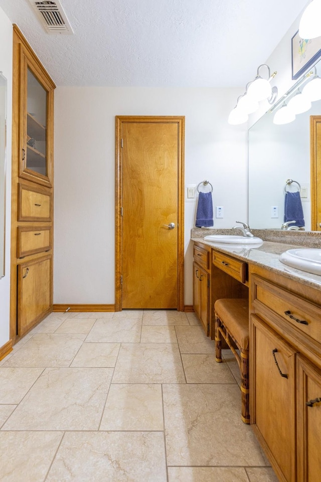 1211 Tall Pines Dr, Friendswood, TX 77546 - full bathroom with double vanity and baseboards