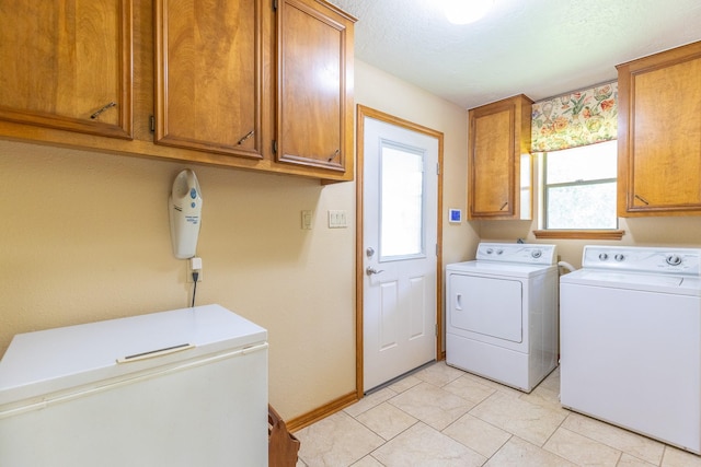 1211 Tall Pines Dr, Friendswood, TX 77546 - laundry area with washing machine and clothes dryer and cabinet space