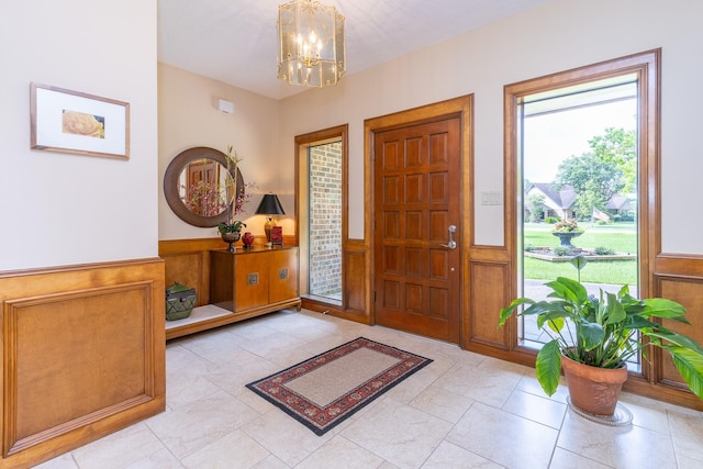 1211 Tall Pines Dr, Friendswood, TX 77546 - entryway with a chandelier, a wainscoted wall, and a decorative wall