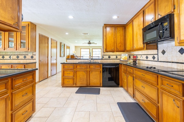 1211 Tall Pines Dr, Friendswood, TX 77546 - kitchen with black appliances, brown cabinets, a peninsula, recessed lighting, and a textured ceiling