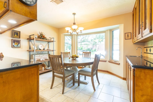 1211 Tall Pines Dr, Friendswood, TX 77546 - dining area with a chandelier and baseboards