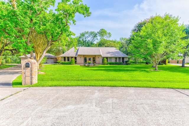 1211 Tall Pines Dr, Friendswood, TX 77546 - ranch-style home featuring a front lawn and concrete driveway