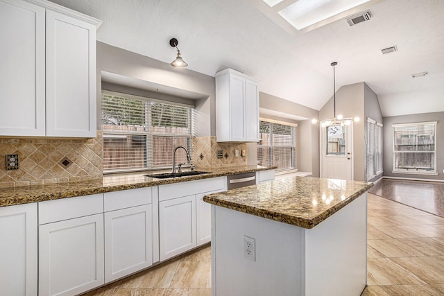 3311 Baden Oaks Ct, Katy, TX 77494 - kitchen featuring tasteful backsplash, white cabinets, dark stone counters, a kitchen island, and dishwasher