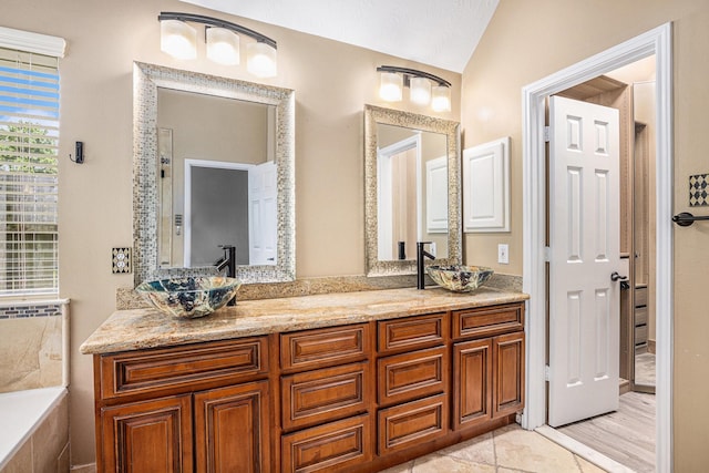 3311 Baden Oaks Ct, Katy, TX 77494 - bathroom with lofted ceiling, double vanity, and a tub