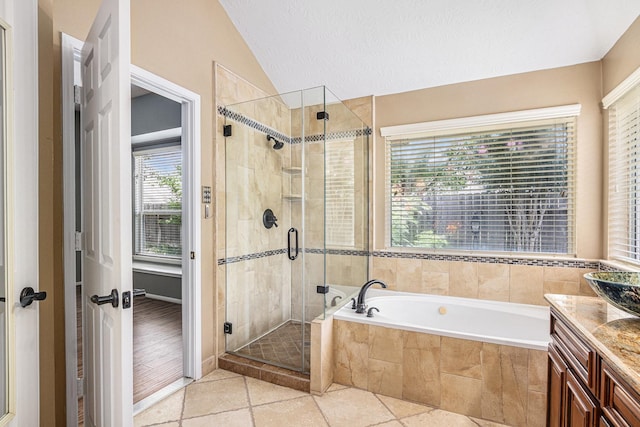 3311 Baden Oaks Ct, Katy, TX 77494 - bathroom featuring lofted ceiling, a bath, vanity, a shower stall, and tile patterned floors